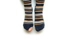 The feet with well worn striped socks isolated on a white background. Royalty Free Stock Photo