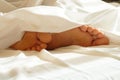 Feet in white bedding