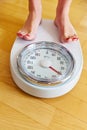 Feet of a woman on bathroom scale