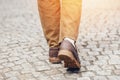 feet of woman in a brown shoes on the city street Lifestyle Travel concept Royalty Free Stock Photo