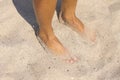 Feet of a woman in fine white beach sand Royalty Free Stock Photo