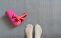 Feet of woman on mat from top.Lady Standing on mattress with socks. Pink dumbbells and towel ready to make flooring muscular Royalty Free Stock Photo