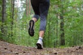 The feet of a woman running along the trail Royalty Free Stock Photo