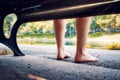 Feet of a woman sitting on a bench near the lake or pond Royalty Free Stock Photo