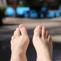 Feet of Woman Sunbathing by a Pool in Madeira Royalty Free Stock Photo