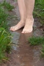 feet of woman walking barefoot through the puddles after the rain Royalty Free Stock Photo