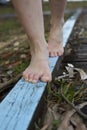 Feet of a woman walking on a blue painted wood. Royalty Free Stock Photo