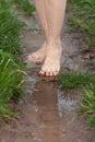 Feet of woman walking through the puddles after the rain Royalty Free Stock Photo