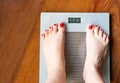 Feet of a woman who wants to lose weight on a scale Royalty Free Stock Photo