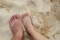 The feet of women and men stepping on the sand on the beach. Royalty Free Stock Photo