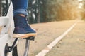 Feet women with white bicycle in nature background