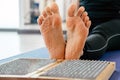 Feet and wooden board with sharp metal nails. Sadhu foot board. Yoga relaxation practice training