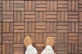Feet on wooden floor. Top view Royalty Free Stock Photo
