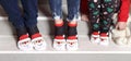 Feet in wool socks near fireplace in winter. Closeup image of family in warm knitted socks lying next to fireplace Royalty Free Stock Photo