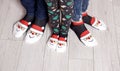 Feet in wool socks near fireplace in winter. Closeup image of family in warm knitted socks lying next to fireplace Royalty Free Stock Photo