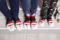 Feet in wool socks near fireplace in winter. Closeup image of family in warm knitted socks lying next to fireplace Royalty Free Stock Photo