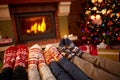 Feet in wool socks near fireplace in winter Royalty Free Stock Photo