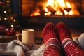 Feet in wool socks near fireplace in winter time. Christmas and new year holidays Royalty Free Stock Photo