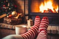 Feet in wool socks near fireplace in winter time. Christmas and new year holidays Royalty Free Stock Photo