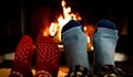 Feet in woolen socks in front of a warm fireplace on a cold winters evening Royalty Free Stock Photo