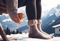 Feet in woollen socks by the Alps mountains view