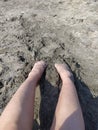 Feet's and legs on sand