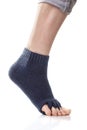 Feet with yoga toe separator socks on white background