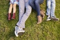 Feet of a young family lying on grass in a park, crop shot Royalty Free Stock Photo