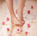 Feet of a young female on a wooden floor