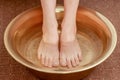 Feet of young woman immersed in water