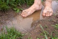 Feet of young woman in puddles after rain, closeup Royalty Free Stock Photo