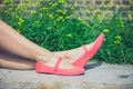 Feet of young woman relaxing on bench outside Royalty Free Stock Photo