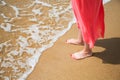 Feet of a young woman on a sandy beach Royalty Free Stock Photo