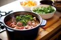 feijoada cooking process with meat and beans in a large pot