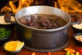 Feijoada. Traditional Brazilian food. Background with fire
