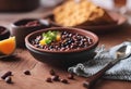 FEIJOADA on a wooden table in a clay bowl