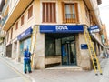 Worker cleaning the facade of the Spanish BBVA
