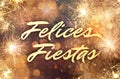 Felices Fiestas. Festive greeting card with happy holiday`s wishes in Spanish on bright background Royalty Free Stock Photo