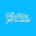 Felicidades Por Tu Santo translated from Spanish handwritten phrase Congratulations For Your Saint on blue background.