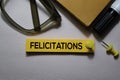 Felicitations text on sticky notes isolated on office desk