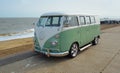 Classic Green and white VW Camper Van parked on Seafront Promenade. Royalty Free Stock Photo