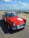 Classic Red Ford Anglia in vintage car rally on Felixstowe seafront. Royalty Free Stock Photo