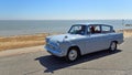 Classic Grey Ford Anglia Car being driven along Seafront Promenade. Royalty Free Stock Photo