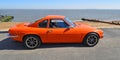 Classic Orange Ginetta Motor Car Parked on Seafront Promenade. Royalty Free Stock Photo