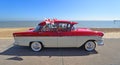 Classic Red and Cream Vauxhall Victor SuperMotor Car Parked on Seafront Promenade. flying flags of St George.