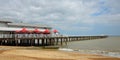 Felixstowe Pier beach and sea with red parasols.