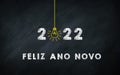 Feliz Ano Novo 2022. Happy New Year in Portuguese Idiom On chalkboard. Creative Concept. 2022 Light Bulb On Blackboard with Royalty Free Stock Photo