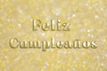 Golden `Feliz CumpleaÃÂ±os` text on festive background