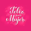 Feliz Dia de la Mujer - Happy Womens Day in Spanish. Calligraphy hand lettering on hot pink background with bokeh