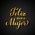 Feliz Dia de la Mujer - Happy Womens Day in Spanish. Gold inscription on black background. International Womans day